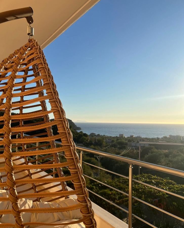 Balcony view from Apollon's Apartments over Himarë bay at sunset